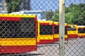 Warsaw city bus depot old rusty fence yellow red buses parked in a row in parking spaces Royalty Free Stock Photo