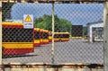 Warsaw city bus depot old rusty fence yellow red buses parked in a row in parking spaces Royalty Free Stock Photo