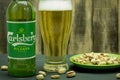 Warsaw, Poland - April 26, 2021: Cool Carlsberg beer in a glass bottle on a wooden background