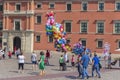 Balloon seller and walking tourists on Castle Square in Warsaw