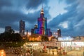 Illuminated Palace of Culture and Science with skyscrapers and entrance metro centrum in city center of Warsaw in the evening Royalty Free Stock Photo