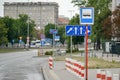 WARSAW. POLAND - AUGUST 2015: Lane direction signs, public transport stop sign, red and white fence posts.