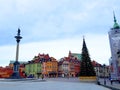 Christmas tree, Royal Castle, ancient colorful townhouses and Sigismund`s Column in Old town Royalty Free Stock Photo