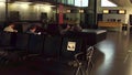 WARSAW, POLAND - DECEMBER, 24 Passengers at international airport terminal departure lounge. Reserved seats for pregnant