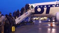 WARSAW, POLAND - DECEMBER, 23 People boarding LOT airlines plane on the airfield