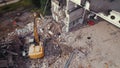 06.08.2022 - Warsaw, Poland - The excavator crusher taking down an old building, working on the demolition site. Royalty Free Stock Photo