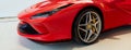 Warsaw/Poland - 04.17.2020: Front of the latest red Ferrari F8 Tributo partly covered with a cover.