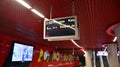 A modern live departure train board above a Warsaw platform.