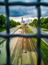 Panorama of Warsaw full of skyscrapers seen from behind the fence on the viaduct over the tram stop