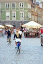 Sexy girl rides bicycle around city. Woman in short shorts traveling in Warsaw Royalty Free Stock Photo