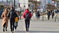 Warsaw, Poland. 8 March 2023. Crowd of people walking down an urban sidewalk Royalty Free Stock Photo