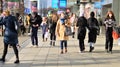 Warsaw, Poland. 8 March 2023. Crowd of people walking down an urban sidewalk Royalty Free Stock Photo