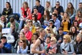 Front view of public heads contemplate city marathon runners.