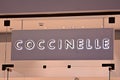 Sign Coccinelle. Company signboard Coccinelle.