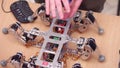 WARSAW, POLAND - MARCH, 4, 2017. Young man showing his DIY hexapod robot on the desk