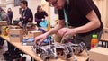 WARSAW, POLAND - MARCH, 4, 2017. Young nerdy man repairing DIY hexapod robot. 4K video