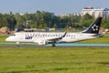 LOT Polskie Linie Lotnicze Embraer 175 airplane Warsaw airport Star Alliance special colors Royalty Free Stock Photo