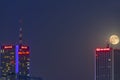 Warsaw, Poland May 30, 2018: Night panorama of Warsaw with new constructions, at night with moon rising from behind of a Royalty Free Stock Photo