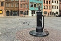 WARSAW, POLAND - MAY 12, 2012: Old vintage pump in the Warsaw Old Town Market Place Rynek Starego Miasta.