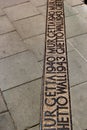 Sign on the ground where the wall of the Jewish Warsaw ghetto was located during the Second World War