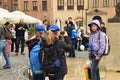 WARSAW, POLAND - MAY 12, 2012: Unknown tourists take pictures in the Warsaw Old Town Market Place