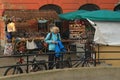 WARSAW, POLAND - MAY 12, 2012: Unknown young woman near small street souvenirs store in New Town