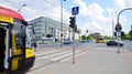 Road intersection and city traffic with cars and trams in Zoliborz district during the day.