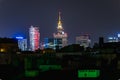 Beautiful night cityscape of high skyscrapers of Warsaw city highlighted by colorful lights