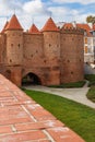 Beautiful red brick old town fortifications with defensive walls and towers and warsaw Barbican Royalty Free Stock Photo