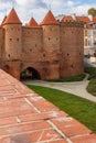 Beautiful red brick old town fortifications with defensive walls and towers and warsaw Barbican Royalty Free Stock Photo