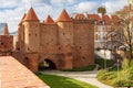 Beautiful red brick old town fortifications with defensive walls and towers and warsaw Barbican Royalty Free Stock Photo