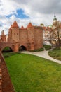 Beautiful red brick old town fortifications with defensive walls and towers and warsaw Barbican