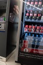 Warsaw, Poland - October 16, 2021: Cold drinks at the vending machine. Carbonated drinks in bottles and cans. Vending machine with