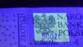 Warsaw, Poland 01.01.2021 Polish Zloty banknote under the UV counterfeit testing