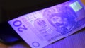 Warsaw, Poland 01.01.2021 20 Polish Zloty banknote under the UV lamp - testing equipment for recognizing fake money