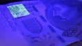 Warsaw, Poland 01.01.2021 Polish zloty under the UV lamp. Testing paper money for counterfeiting concept. extreme close Royalty Free Stock Photo