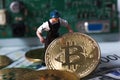WARSAW / POLAND - September 23 2018: bitcoins new virtual currency. A worker is digging on golden bitcoin with dollar background Royalty Free Stock Photo