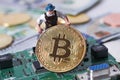 WARSAW / POLAND - September 23 2018: bitcoins new virtual currency. A worker is digging on golden bitcoin with dollar background Royalty Free Stock Photo