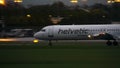 WARSAW, POLAND - SEPTEMBER 14, 2017. Fokker 100 Helvetic Airways commercial airplane landing the Chopin airport at night Royalty Free Stock Photo