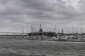 Warship and boat marina vista in Charleston bay on a heavily overcast day