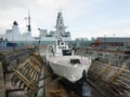 Warship M33 in drydock with HMS dauntless in the background Royalty Free Stock Photo