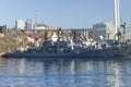 Warships of the Russian Pacific Fleet - cruiser, frigate and destroyer, at the pier in the center of Vladivostok