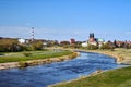 Warta river, industrial chimney and cathedral towers