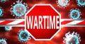 Wartime and coronavirus, symbolized by a stop sign with word Wartime and viruses to picture that Wartime affects the future of
