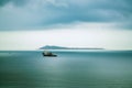 Lonely ship on Cloudy ocean with huge clouds
