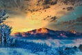 Dawn is breaking over the snowy horizon on the mountain of Pikes Peak