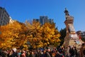 Protestors of Occupy Canada gathering at statue Victoria Square, Montreal, Canada during fall autumn with yellow leaves on trees Royalty Free Stock Photo