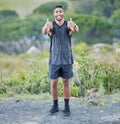 That was a good run. Full length shot of a handsome young man standing alone and showing a thumbs up after his outdoor