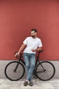 It was great ride Handsome and young man with stubble in casual clothes leaning at his bicycle and looking aside while Royalty Free Stock Photo