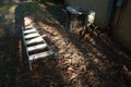 Step ladder next to heat pump outside at sunrise 